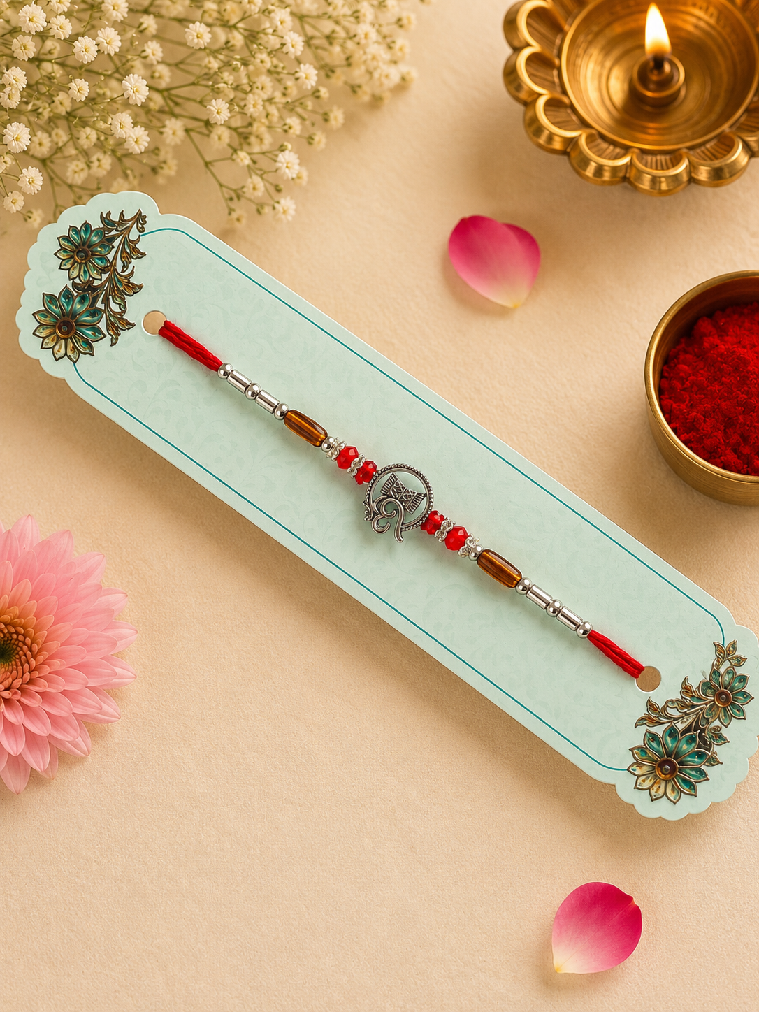 Silver Om Divine Rakhi with Red Crystal Beads K39
